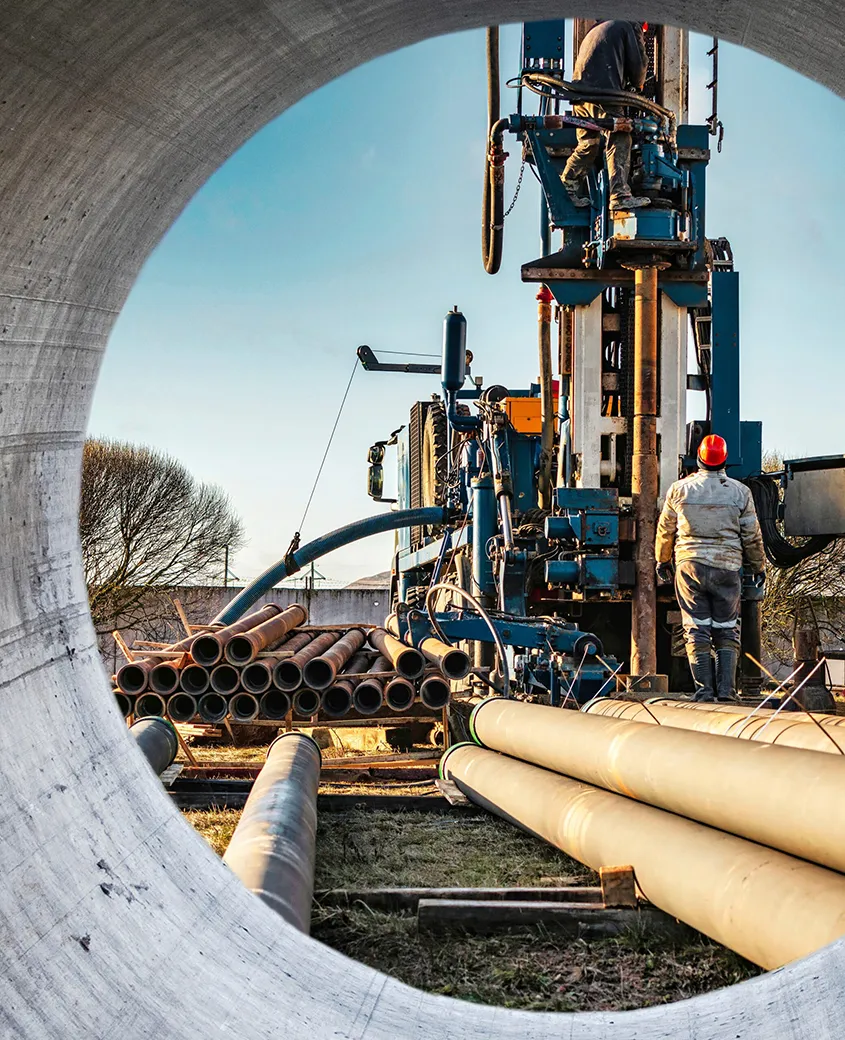 Drill rig viewed through a large pipe