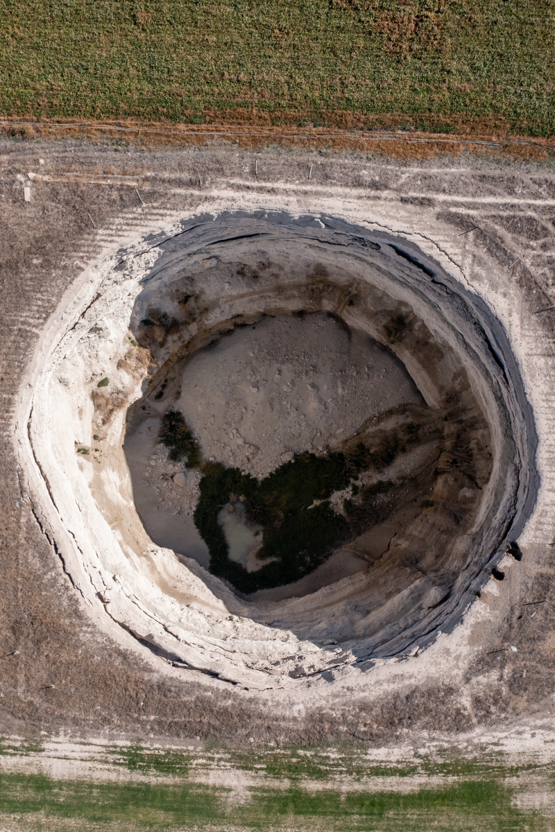 Large sinkhole in the middle of a field